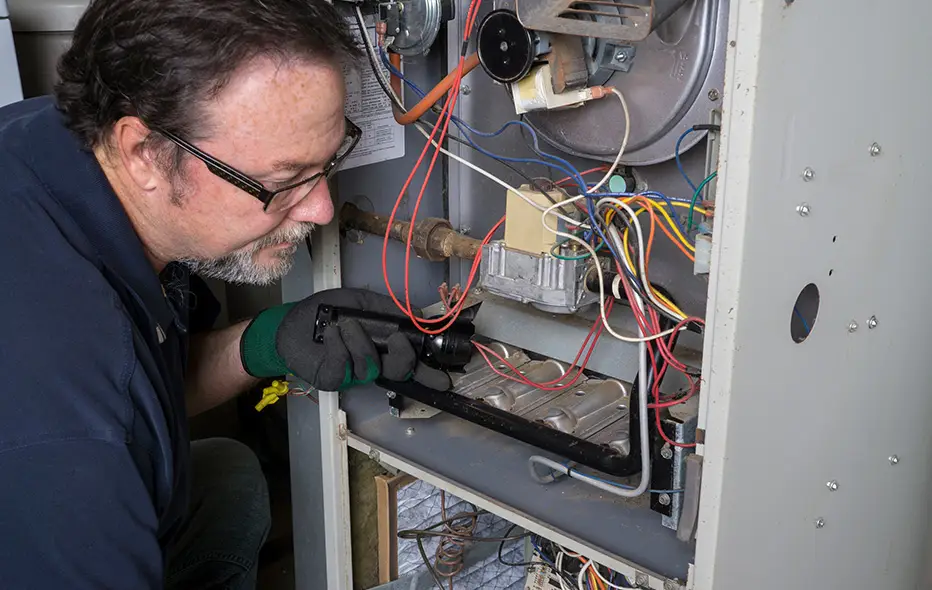 HVAC expert repairing a furnace