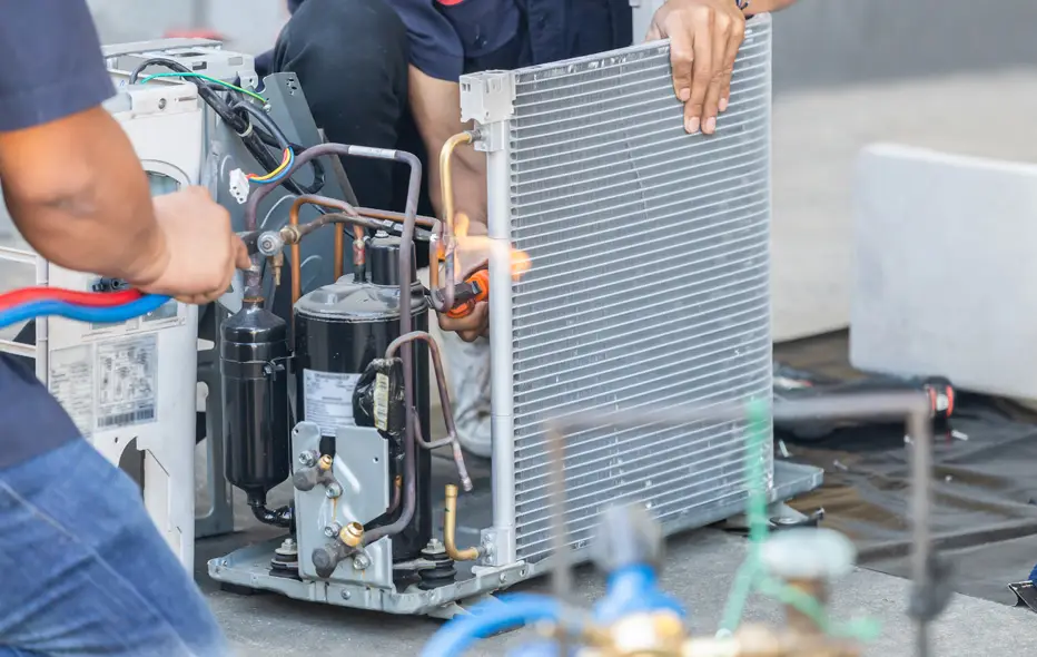HVAC experts repairing an AC unit